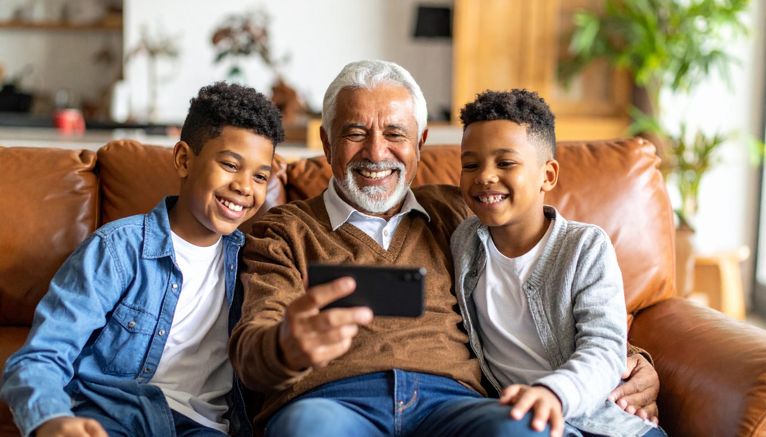 Grandpa and grandkids taking a selfie to upload to Social Media