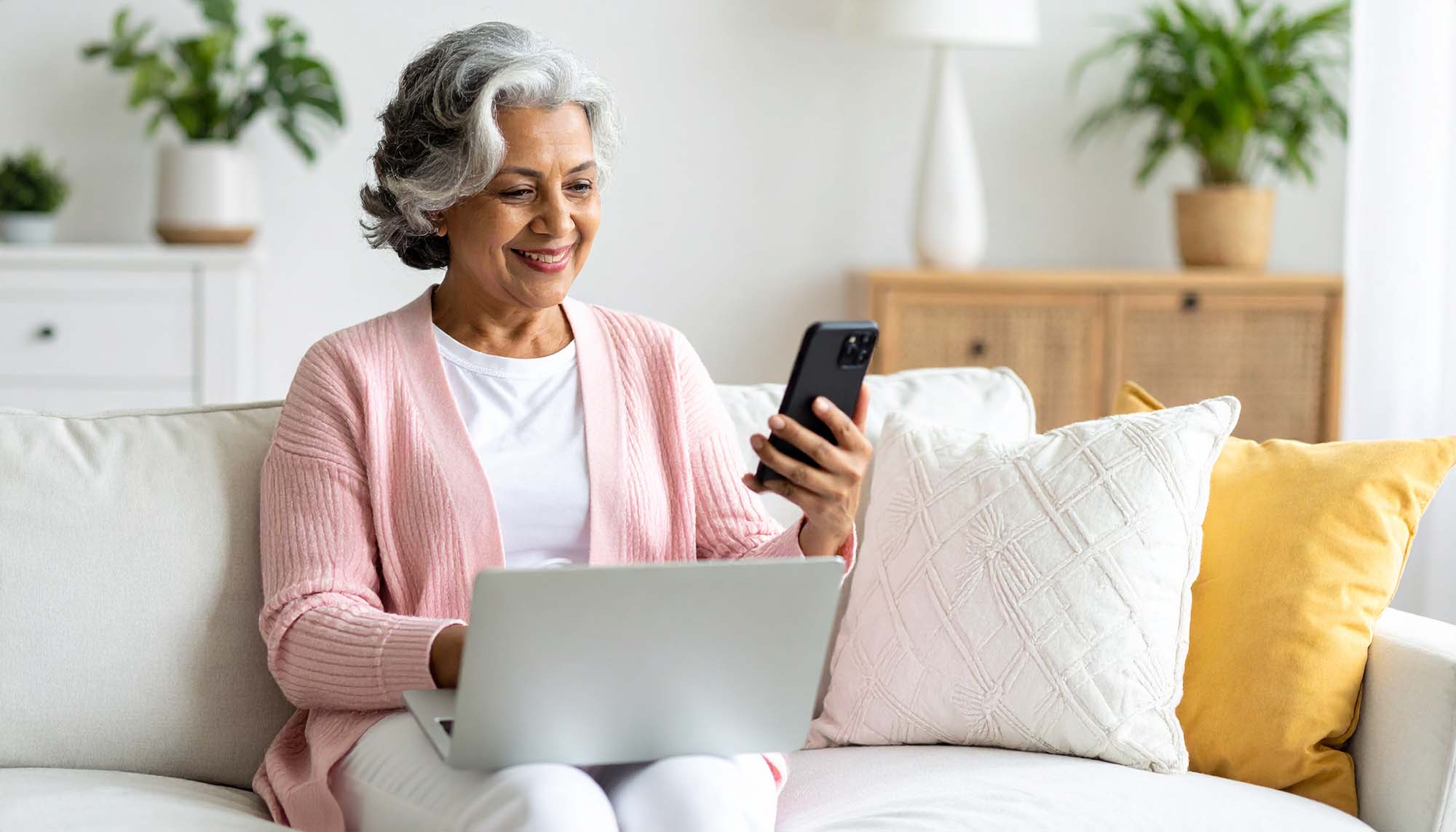 Senior enjoying staying connected online while being safe, after attending our free workshops at safeboomer.com
