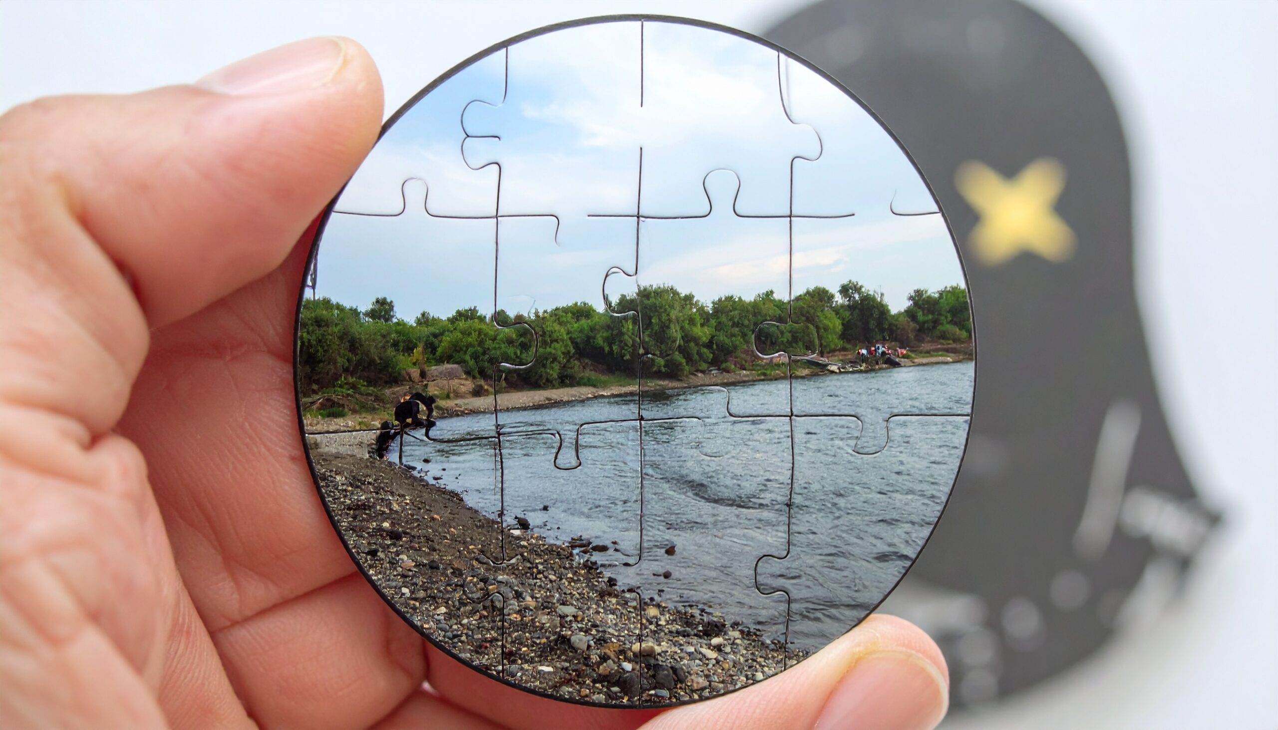 Photo of up close mirror reflecting water and a specific location on the map.
