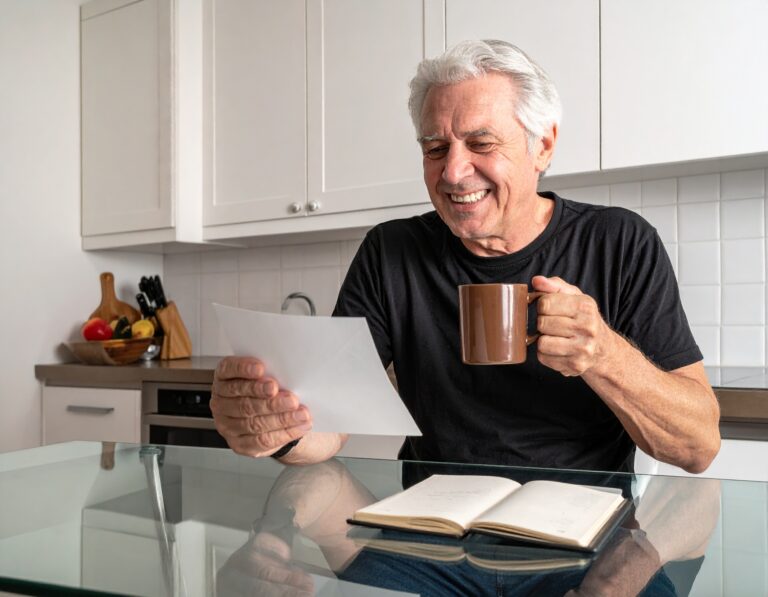 Senior reading list of passwords written down and stored in a safe place inside his home, just in case he forgets his passwords.
